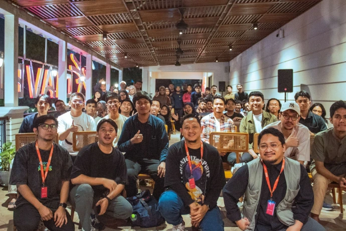A diverse group of people gathered indoors for an event.